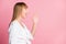 Profile side photo of young woman yell shout announcement news look empty space isolated over pink color background