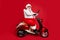 Profile side view of his he nice fat wondered funky Santa sitting on moped holding in hand laptop reading wish dream