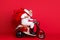 Profile side view of nice bearded gray-haired Saint Nicholas riding motor delivering carrying desirable purchase things