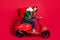 Profile side view portrait of attractive childish glad cheerful guy riding moped delivering gifts sack St Nicholas