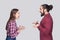 Profile side view portrait of funny surprised bearded man and woman in casual style standing and looking at each other with amaze