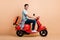 Profile side view portrait of nice cheerful guy driving moped carrying bag going airport railway station isolated over