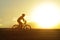 Profile silhouette sport man riding cross country mountain bike