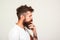 Profile of smart and creative handsome man over white background. Bearded man is thinking, trying solve problem. Hipster making