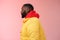 Profile studio shot bearded young 25s african guy in yellow jacket red hoodie look left normal unbothered relaxed