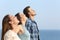 Profile of three friends breathing fresh air on the beach