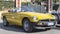 Profile view of beautiful yellow cabriolet vintage car model MG MGB