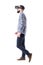 Profile view of business man watching virtual reality headset walking