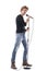 Profile view of cool handsome rock music singer posing with microphone on stand