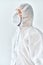 Profile view of doctor in protective medical suit, face mask and glasses