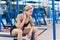 Profile view of a female athlete doing some tricep dips on a park bench.