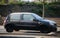 Profile view of frozen black Renault Clio parked in the street, Renault is the popular brand of french cars