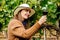 Profile view of a happy woman winemaker tasting red wine