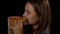 Profile view of a lovely woman eating a hamburger in slow motion