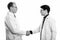 Profile view of mature man doctor and young man doctor shaking hands