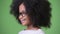 Profile view of young cute African girl with Afro hair smiling