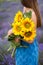 Profile view of young woman holding a flower bouquet