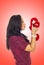 Profile of woman kissing heart toy