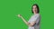 Profile of woman pointing finger over green background