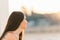 Profile of a young woman gazing the horizon during sunset from a park