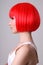Profile of young woman in red wig