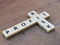 PROFIT RISK crossword by square letter tiles against wooden background.