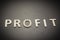Profit written with wooden letters on a gray background