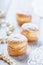 Profiterole or cream puff cakes filled with whipped cream on wooden background close up. Delicious dessert with decor.