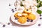 Profiteroles with blueberries. Custard cakes, Eclair, cream puff on a wooden stand