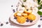 Profiteroles with blueberries. Custard cakes, Eclair, cream puff on a wooden stand