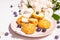 Profiteroles with blueberries. Custard cakes, Eclair, cream puff on a wooden stand