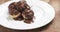 Profiteroles with fine dark chocolate on plate