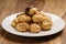 Profiteroles with fine dark chocolate on plate