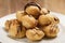 Profiteroles with fine dark chocolate on plate