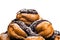 Profiteroles in a heap rich Belgian chocolate closeup white background