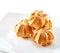 Profiteroles on plate close-up isolated