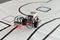 Programmable robot with wheels and red lights driving on paper road. robotic car with line follow