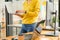 Programmer is standing, carrying and using a laptop to test the system in the office