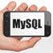 Programming concept: Hand Holding Smartphone with MySQL on display