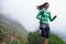 She progresses in her fitness everyday. A young woman sprinting along a mountain road on a crisp morning.