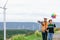 Progressive engineer with his son holding windmill toy in the mountain.