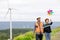 Progressive engineer with his son holding windmill toy in the mountain.