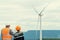 Progressive engineer with his son in the wind farm atop of the mountain.