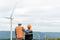 Progressive engineer with his son in the wind farm atop of the mountain.