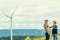 Progressive engineer with his son in the wind farm atop of the mountain.