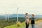 Progressive engineer with his son in the wind farm atop of the mountain.