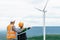 Progressive engineer with his son in the wind farm atop of the mountain.