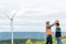 Progressive engineer with his son in the wind farm atop of the mountain.