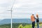 Progressive engineer with his son in the wind farm atop of the mountain.