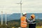 Progressive engineer with his son in the wind farm atop of the mountain.